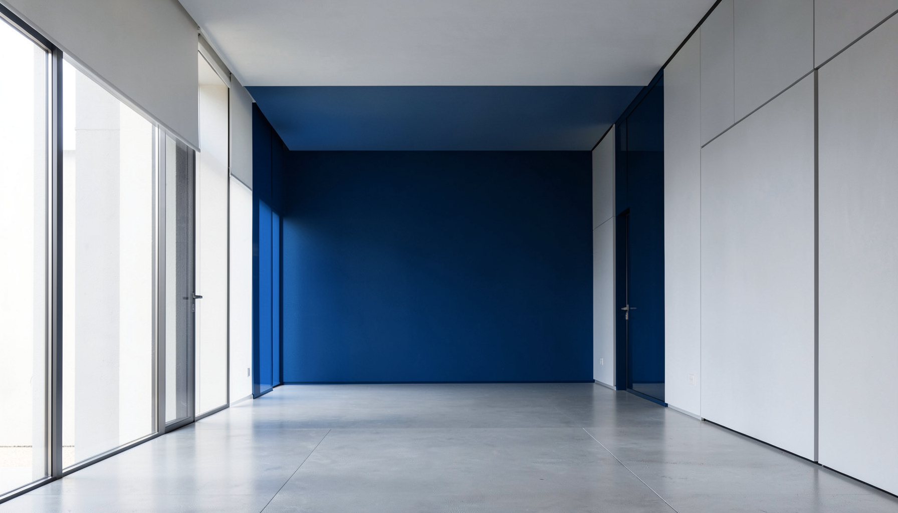 Clean architectural photograph with strong symmetry, a modern interior space with balanced geometric lines and soft natural light